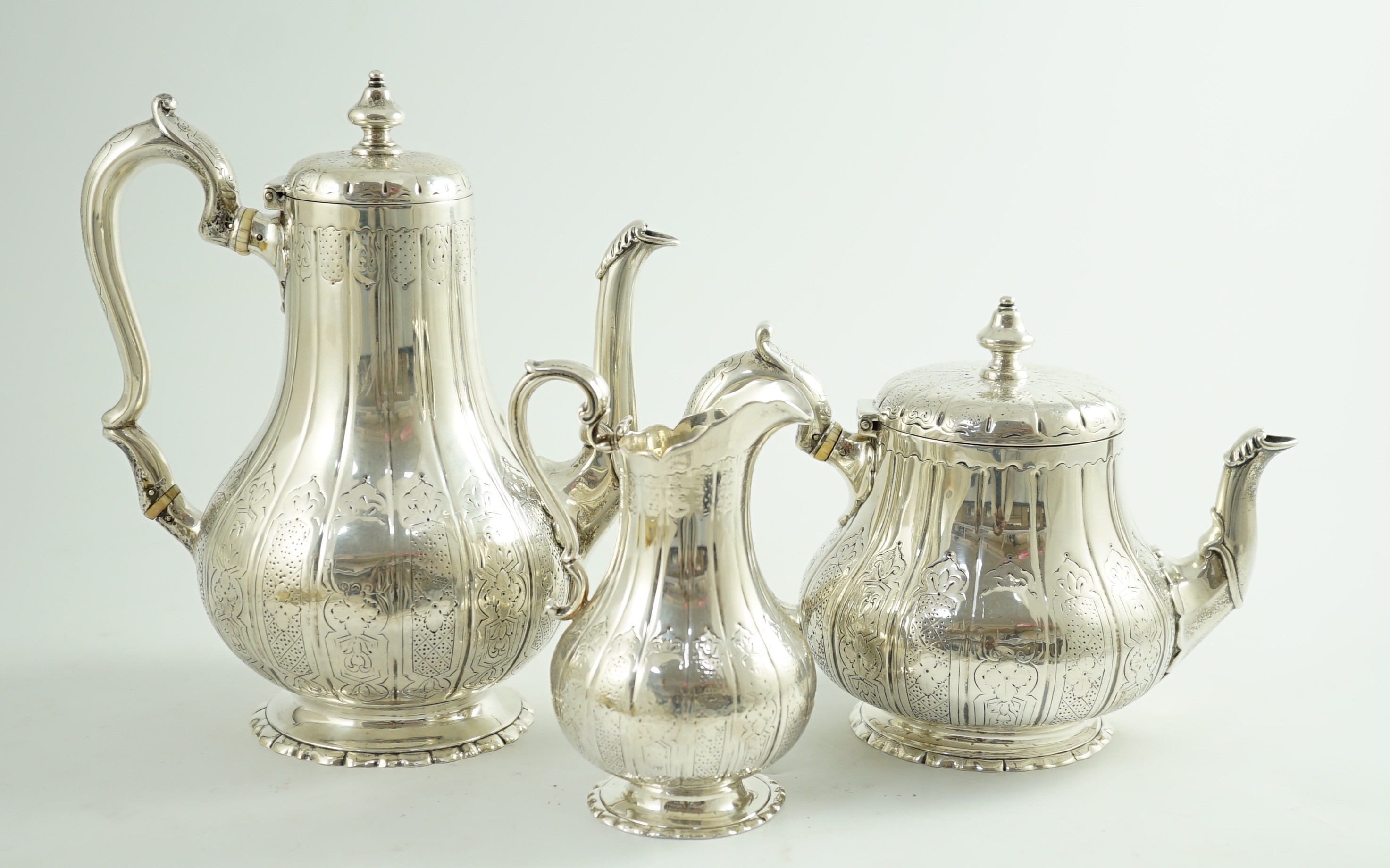 A Victorian silver three piece coffee set, comprising pot, cream and sugar bowl, by Walter Morrisse